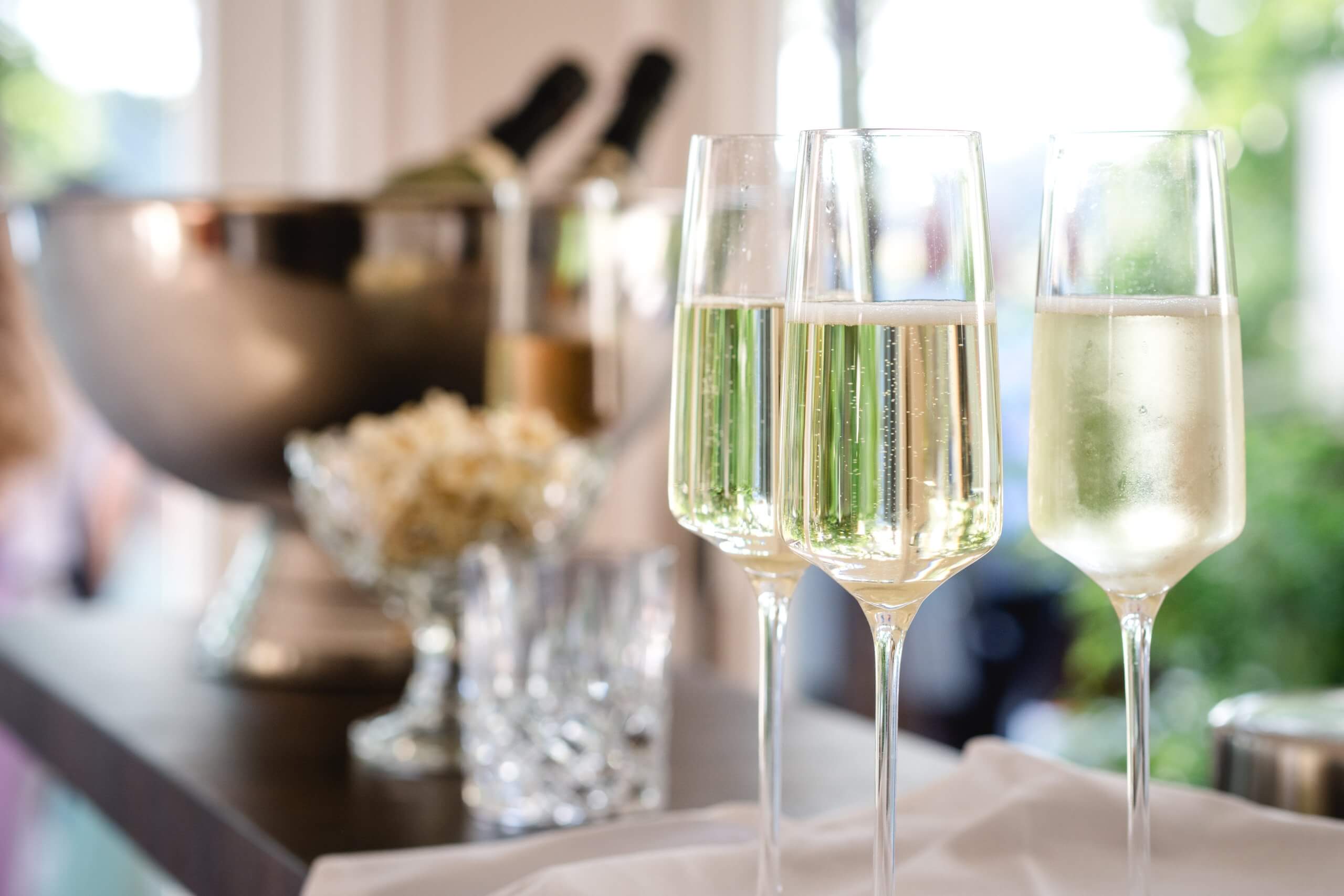several filled champagne glasses in a festive setting, wedding, celebration, party.
